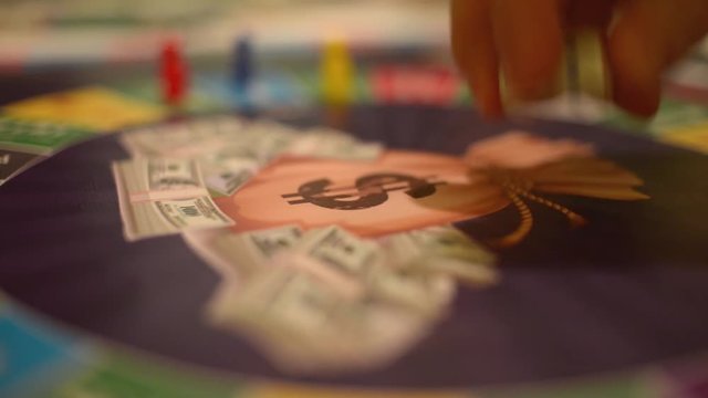 Board Game Cash Flow - a player throws the dice on the field and makes his move