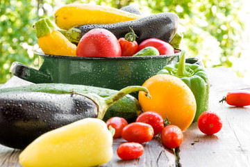 Vegetables. Fresh vegetables on old wooden table. Over nature background 
