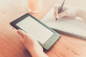 Girl is reading ebook on digital tablet device