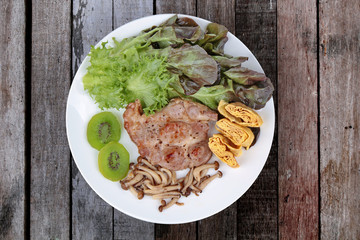 Homemade ,Pork steak  topped omelet with grilled mixed mushroom and mixed vegetable .