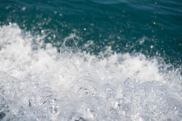 Fototapeta na wymiar Blue water waves in the sea and splashing waves.