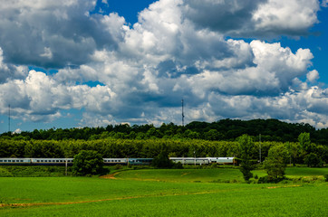 Fototapeta na wymiar Passenger train moving through countryside