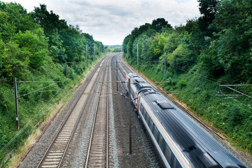 Fototapeta na wymiar Fast train travelling on the tracks, passenger train