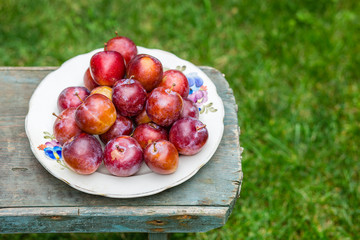 red plums on the table