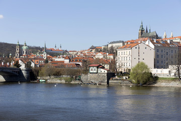 Fototapeta premium Spring Prague gothic Castle with the Lesser Town above River Vltava in the sunny Day, Czech Republic