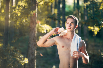 Naklejka premium Fit Young Man in the Forest