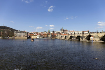 Fototapeta premium Spring Prague gothic Castle and Charles Bridge with the Lesser Town in the sunny Day, Czech Republic