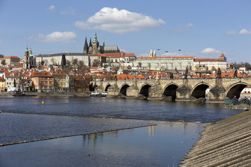 Fototapeta premium Spring Prague gothic Castle and Charles Bridge with the Lesser Town in the sunny Day, Czech Republic