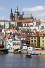 Obraz premium Spring Prague gothic Castle with the Lesser Town above River Vltava in the sunny Day, Czech Republic