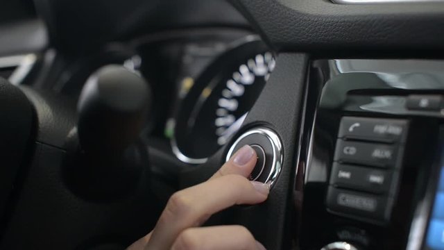 Business Woman Push Start Button In Modern Car For Starting The Engine.