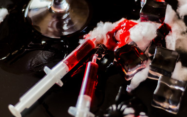 creepy halloween party cocktails with blood, spiders and ice cubes