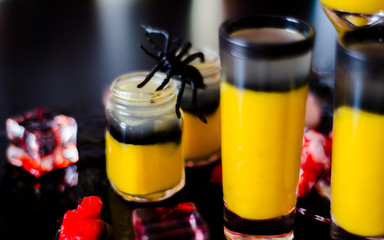 creepy halloween party cocktails with blood, spiders and ice cubes