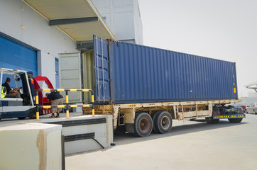 Forklift operator loading cargo in the container