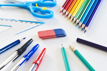 Naklejka premium Different Kind of Colorful School and Office Utensils Arranged on a White Surface