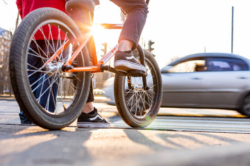 Urban biking - teenage boy riding bike in city