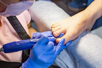 The master does a manicure in the salon