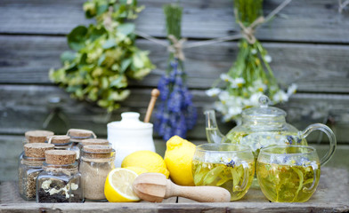 Cup of herbal tea with wild flowers and various herbs 