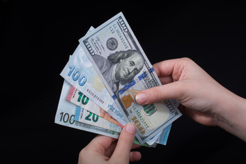 Hand holding American dollar  isolated on black background