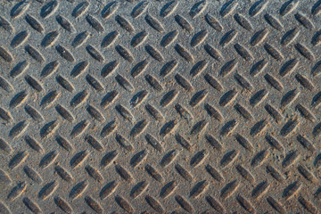 Dusty grungy Industrial Checker Plate Background Texture with Rusty Worn Embossed Raised Diamond...