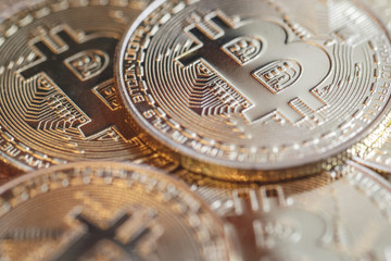 The golden bitcoin on colorful board background, Conceptual image for worldwide crypto currency, huge stack physical version of golden Bitcoin.