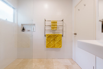 White bathroom with mustard yellow accent towels