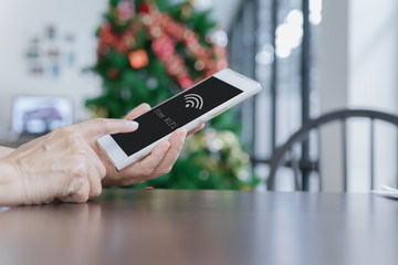 human's finger touched mobile phone  and free wifi connect with clipping path on screen, soft focus