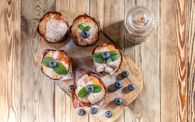 Muffins with blueberries on a wooden background. homemade baking. Top view