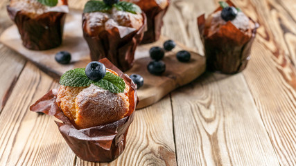 Muffins with blueberries on a wooden background. homemade baking. Banner