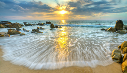Dawn on beautiful beaches with white sand streaks waves like silk to create many beautiful shapes...