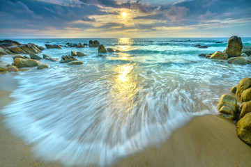 Dawn on beautiful beaches with white sand streaks waves like silk to create many beautiful shapes...