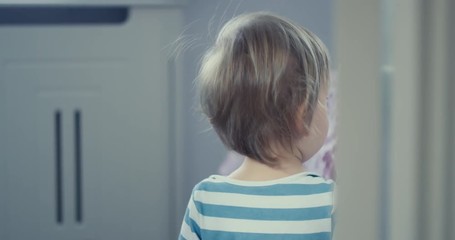 Little toddler boy walking around in the house