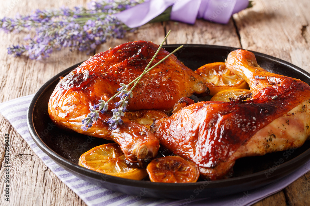 Canvas Prints spicy grilled glazed chicken legs with lavender and lemon close-up on a plate. french cuisine. horiz