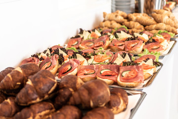 many delicious croissant bread stacked on a buffet line