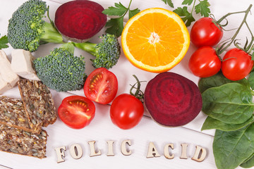 Inscription folic acid with nutritious products containing vitamin B9 and dietary fiber, healthy nutrition concept