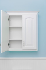 Clean empty white cabinet with one door open