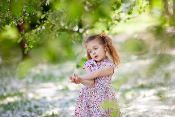Little cute girl walking in summer park