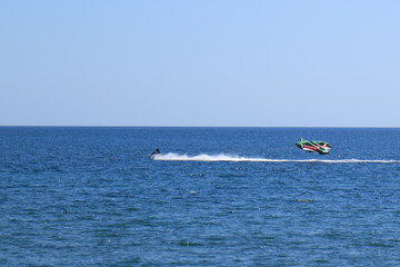 Aquabike raises an inflatable kite with a rider.