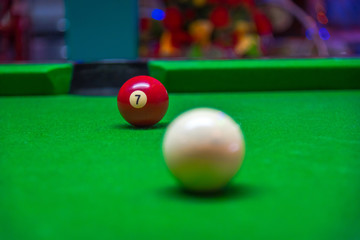 Billiard ball in a green pool table focus on the number one red ball