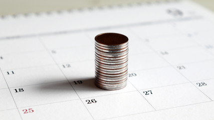 A pile of coins on the calendar.