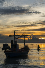 Fototapeta na wymiar Fisherman prepare to work in dawn