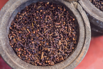 carnation grains, herbal medicinal herbs, dry carnation grains in a dish