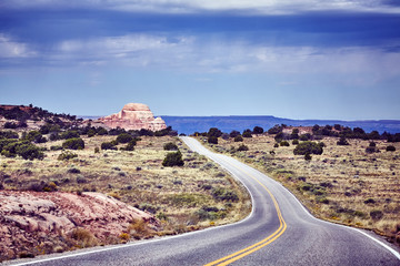 Empty road with dramatic sky, back focus, color toned picture, travel concept, Canyonlands National Park, Utah, USA.