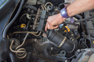 Obraz premium Auto mechanic repairing car. Selective focus.