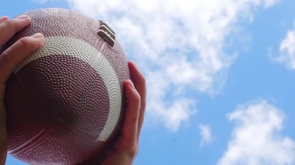 hands catching rugby, football ball, slow motion