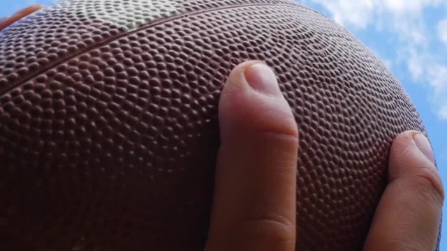 hands catching rugby, football ball, slow motion