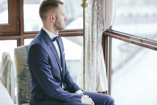 elegant groom in a hotel room