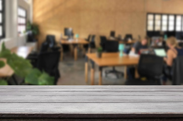 Selected focus empty brown wooden table in office with big windows of the Background with bokeh image. for your photomontage or product display