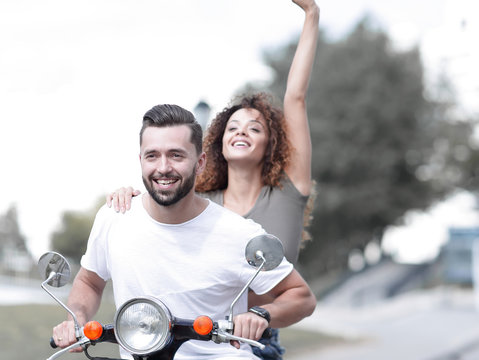 Happy couple driving scooter excited on summer holidays vacation