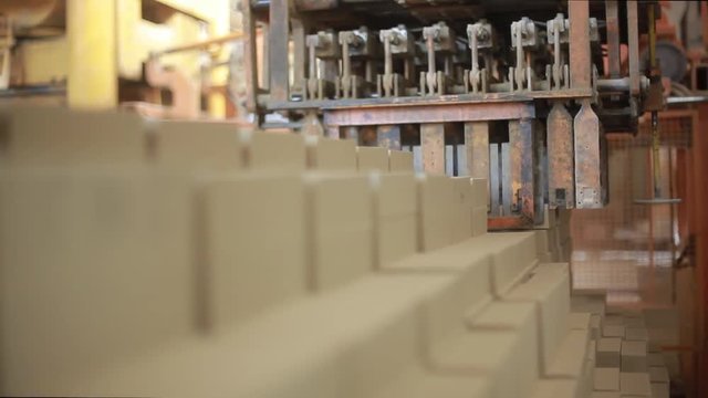 Production of white bricks. The robot truck loads the bricks. Brickworks. Wooden beams and boards neatly stacked in a pyramid shape. Wooden boards neatly stacked in neat rows. Boards for building stan
