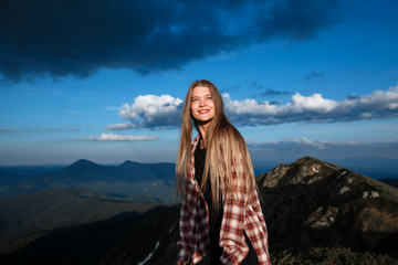 Woman hiker on a top of a mountain. Happy young blonde woman portrait - 210272829
